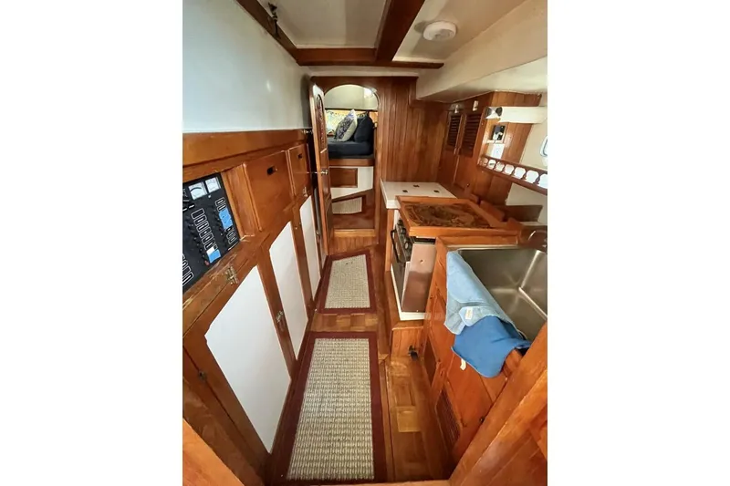 Slide: The Image of Interior of a 1979 Hardin 44 sailboat featuring a wooden galley and cozy cabin space. - 8