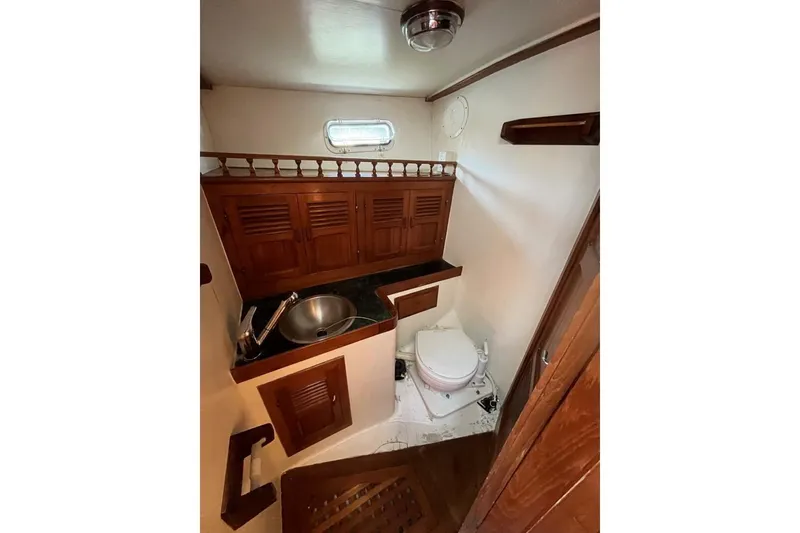 Slide: The Image of 1979 Hardin 44 yacht bathroom with wooden cabinets and compact sink. - 9