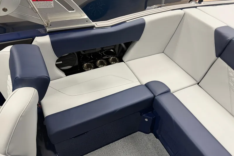 Slide: The Image of 2026 MasterCraft NXT20 boat interior with blue and white seating and cup holders. - 10
