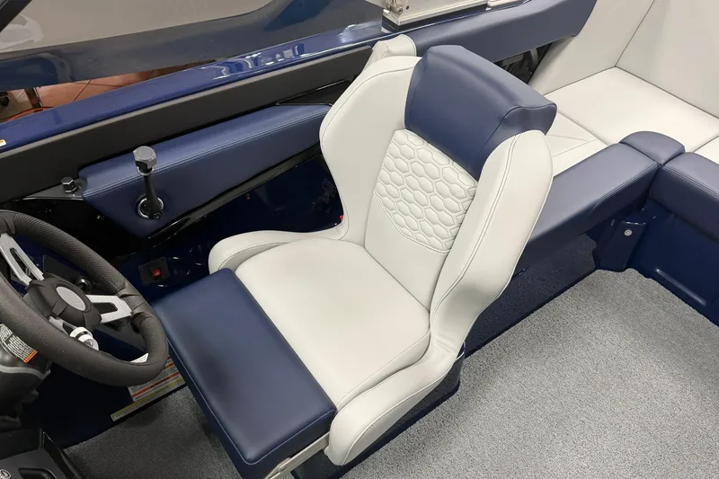 Slide: The Image of 2026 MasterCraft NXT20 boat interior with blue and white seating and steering wheel. - 11