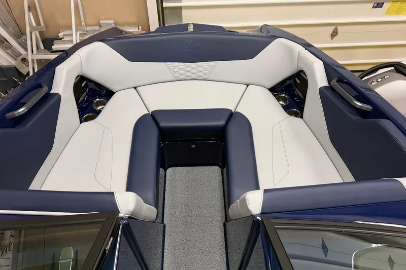 Slide: The Image of 2026 MasterCraft NXT20 boat interior with blue and white seating, showcasing luxury design. - 12