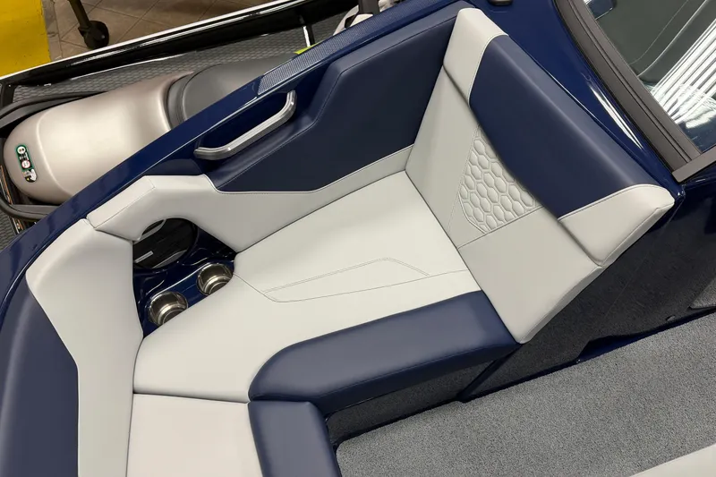 Slide: The Image of 2026 MasterCraft NXT20 boat interior with blue and white seating and cup holders. - 13