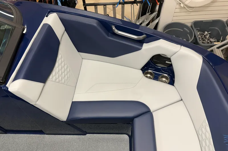 Slide: The Image of 2026 MasterCraft NXT20 boat interior with blue and white seating and cup holders. - 14