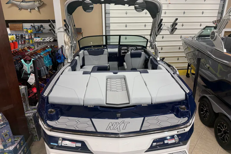 Slide: The Image of 2026 MasterCraft NXT20 boat in showroom, featuring sleek design and modern interior. - 3