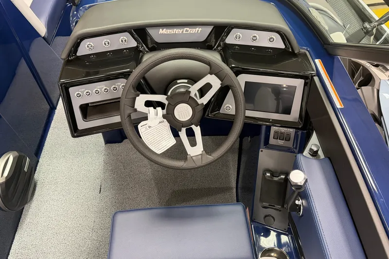 Slide: The Image of 2026 MasterCraft NXT20 boat dashboard with steering wheel and control panel. - 5
