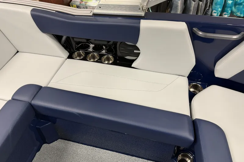 Slide: The Image of 2026 MasterCraft NXT20 boat interior with blue and white seating and cup holders. - 7