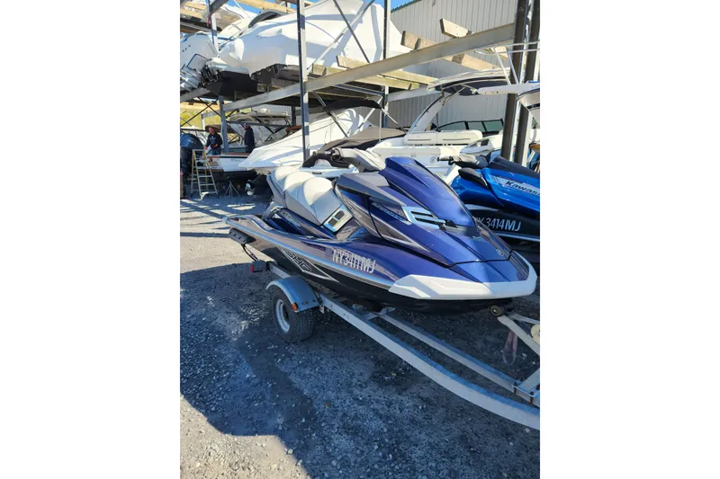 Slide: The Image of 2013 Yamaha FX Cruiser SHO jet ski on trailer, parked outdoors. - 2