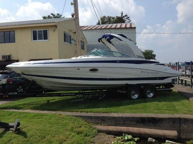 Slide: The Image of 2016 Crownline 285 SS boat on trailer near building. - 2