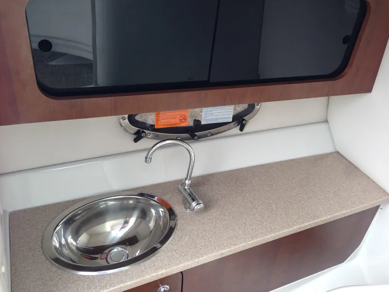Slide: The Image of Interior of 2016 Crownline 285 SS featuring sink and countertop. - 20