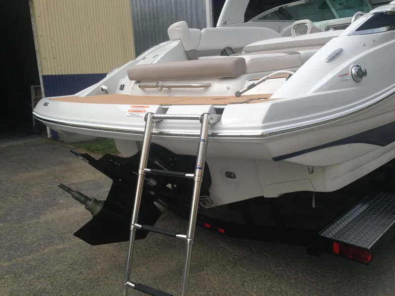 Slide: The Image of Rear view of a 2016 Crownline 285 SS boat with swim ladder. - 35