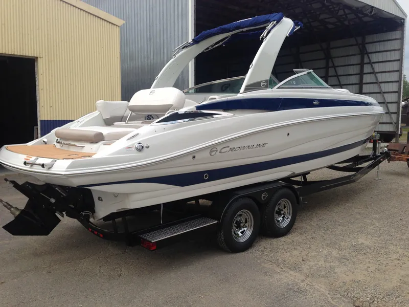 Slide: The Image of 2016 Crownline 285 SS boat on trailer outside warehouse. - 39