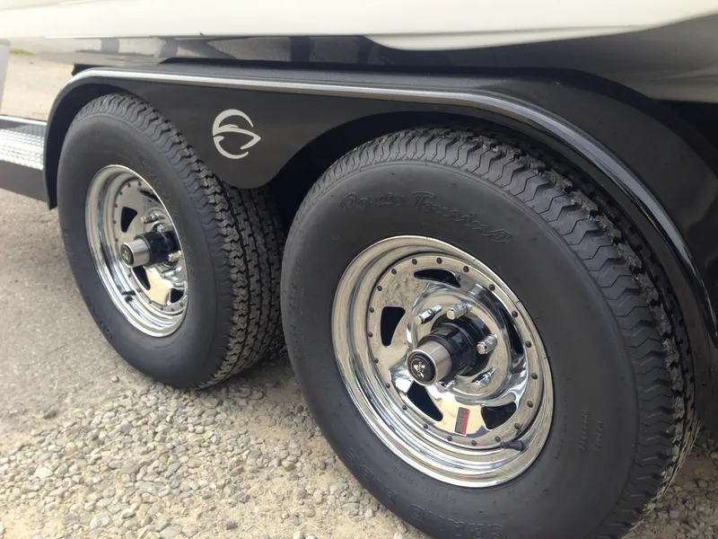 Slide: The Image of 2016 Crownline 285 SS trailer tires on gravel path. - 41