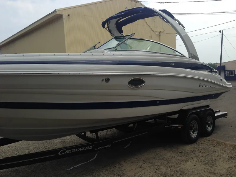 Slide: The Image of 2016 Crownline 285 SS boat on trailer near building. - 6