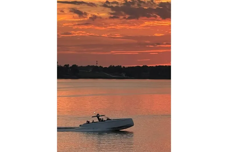 Slide: The Image of 2021 Pardo Yachts P43 cruising at sunset on calm waters. - 11