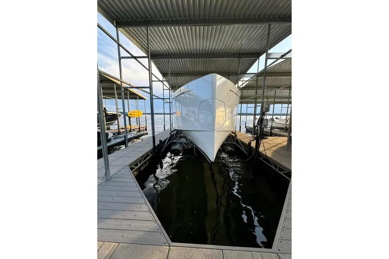 Slide: The Image of Pardo Yachts P43 2021 model docked in a covered marina slip. - 2