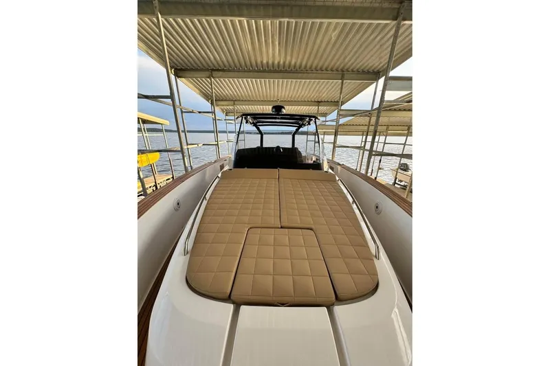 Slide: The Image of 2021 Pardo Yachts P43 with tan cushioned deck, docked under a canopy. - 7