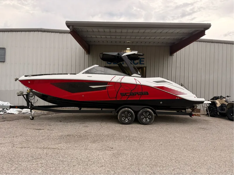 The Image of 2025 Scarab 285 LX boat in red and white on trailer. - 1