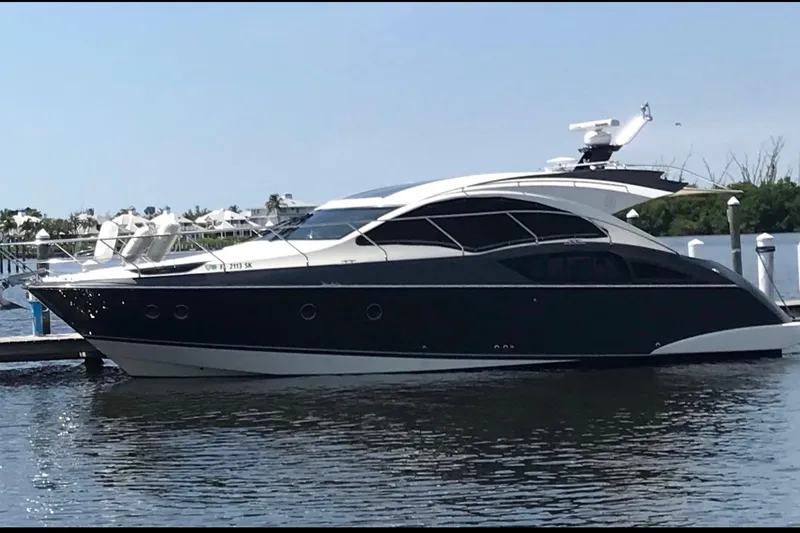 The Image of 2014 Marquis 40 SC yacht docked on calm water, showcasing sleek design. - 1