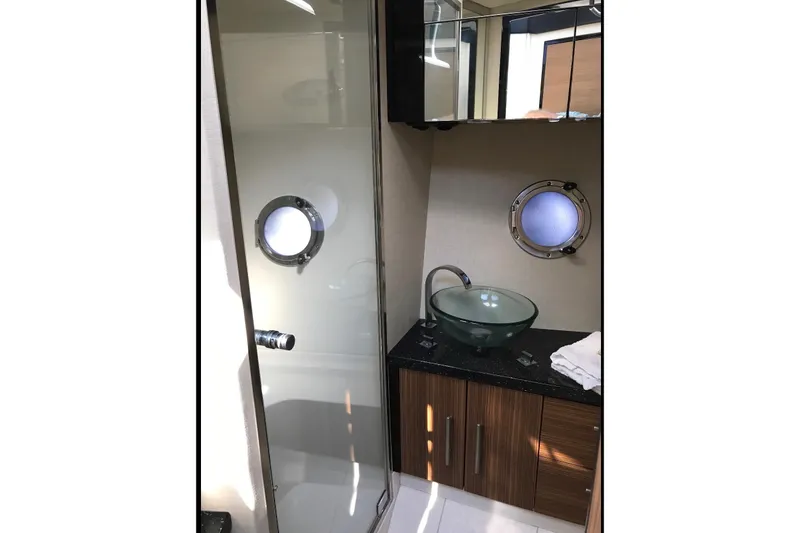 Slide: The Image of Luxurious bathroom in 2014 Marquis 40 SC yacht with glass sink and porthole window. - 10