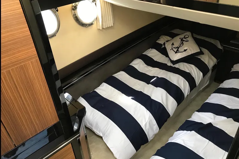 Slide: The Image of Interior of 2014 Marquis 40 SC yacht with nautical-themed twin beds and porthole windows. - 11