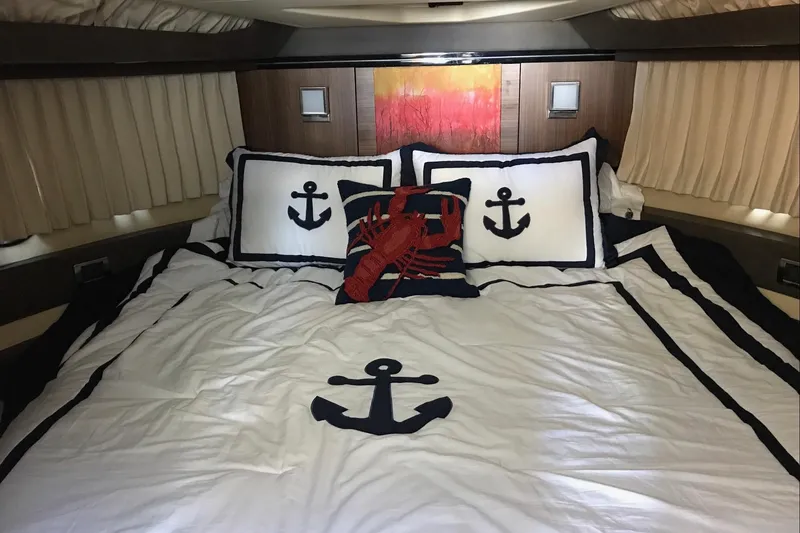 Slide: The Image of Luxurious 2014 Marquis 40 SC yacht bedroom with nautical-themed bedding and decor. - 13