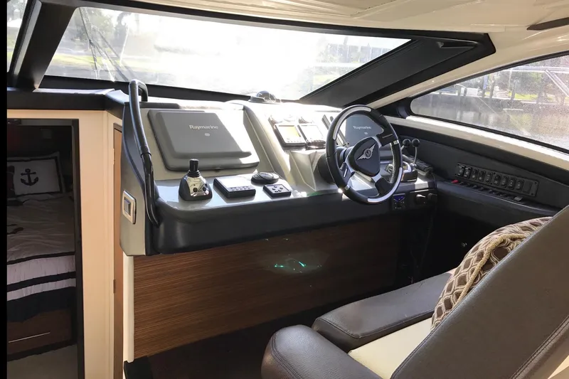 Slide: The Image of Interior helm of 2014 Marquis 40 SC yacht with steering wheel and navigation controls. - 15