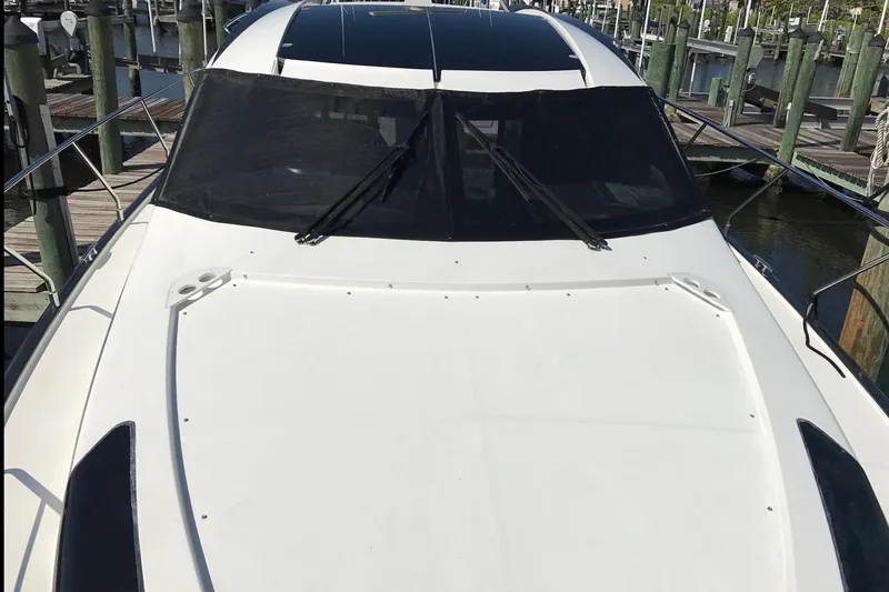 Slide: The Image of 2014 Marquis 40 SC yacht docked at marina, showcasing sleek design and spacious deck. - 4