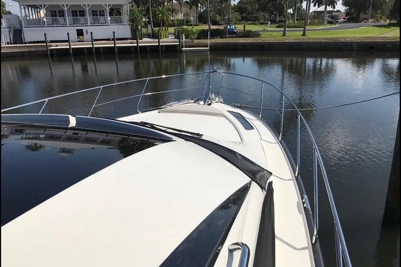 Slide: The Image of 2014 Marquis 40 SC yacht docked by a serene waterfront. - 5