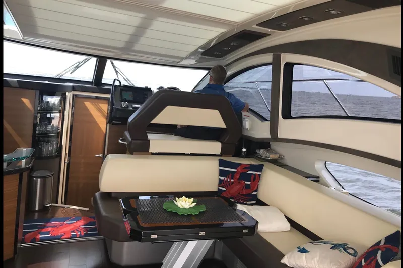 Slide: The Image of Interior of 2014 Marquis 40 SC yacht with modern seating and ocean view. - 6