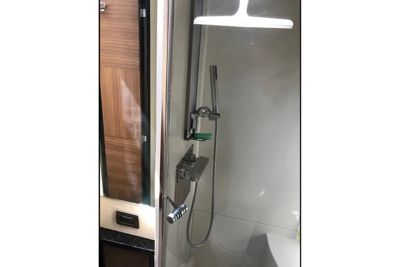 Slide: The Image of Modern shower area in 2014 Marquis 40 SC yacht, featuring sleek fixtures and wood accents. - 9
