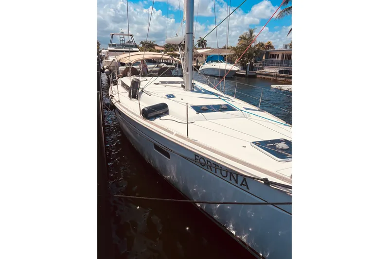 Slide: The Image of 2016 Jeanneau Sun Odyssey 519 sailboat docked under a sunny sky. - 14