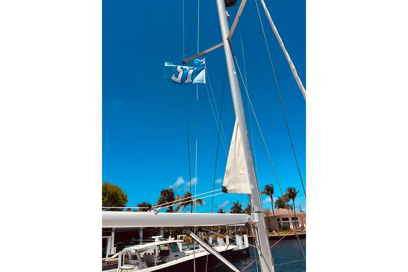 Slide: The Image of Sailboat mast and flag on Jeanneau Sun Odyssey 519, 2016, under clear blue sky. - 20