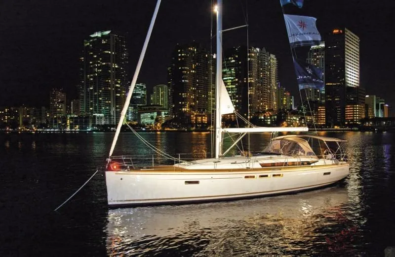 Slide: The Image of Manufacturer Provided Image: 2016 Jeanneau Sun Odyssey 519 sailboat illuminated at night with city skyline backdrop. - 4