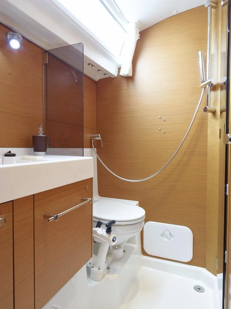 Slide: The Image of Manufacturer Provided Image: Modern bathroom in 2016 Jeanneau Sun Odyssey 519 sailboat with wooden cabinetry. - 8
