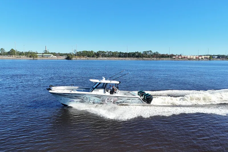 Slide: The Image of 2024 Front Runner 37 Catamaran cruising on a sunny day, creating waves in the water. - 10