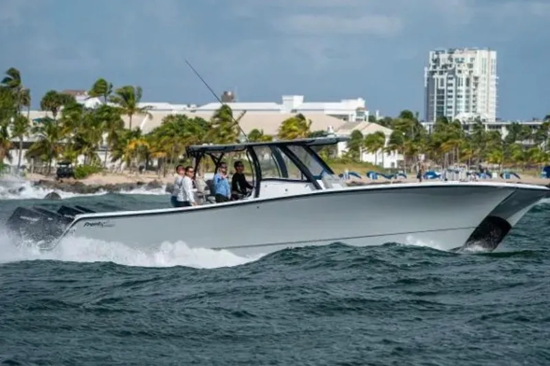 Slide: The Image of 2024 Front Runner 37 Catamaran cruising near a tropical shoreline with palm trees. - 108