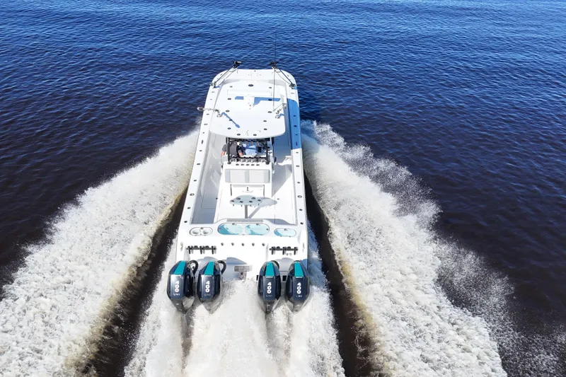 Slide: The Image of 2024 Front Runner 37 Catamaran cruising on open water, rear view. - 13