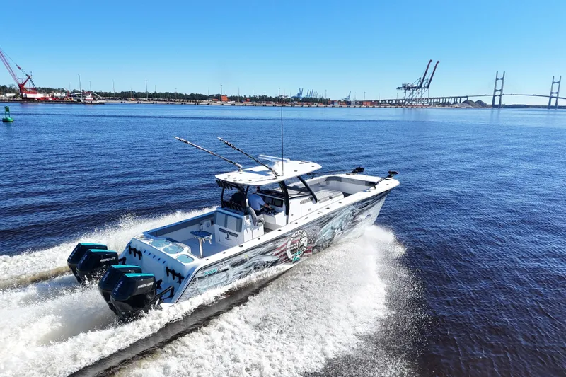 Slide: The Image of 2024 Front Runner 37 Catamaran cruising on a sunny day near a bridge and port. - 15