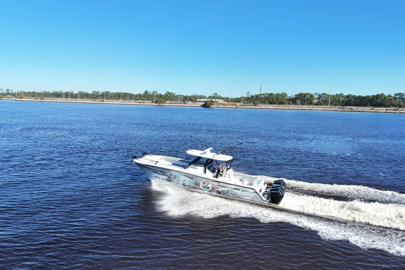 Slide: The Image of 2024 Front Runner 37 Catamaran cruising on a sunny day, creating a wake in the water. - 16