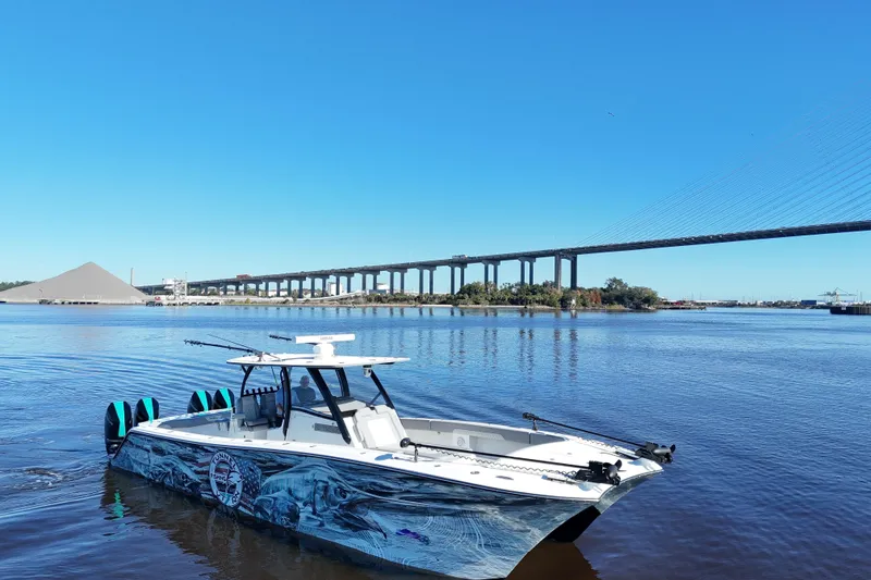 Slide: The Image of 2024 Front Runner 37 Catamaran on a river with a bridge in the background. - 27
