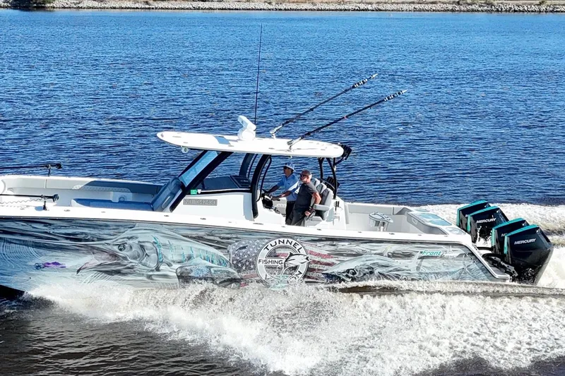 Slide: The Image of 2024 Front Runner 37 Catamaran cruising on water with vibrant fishing-themed graphics. - 5