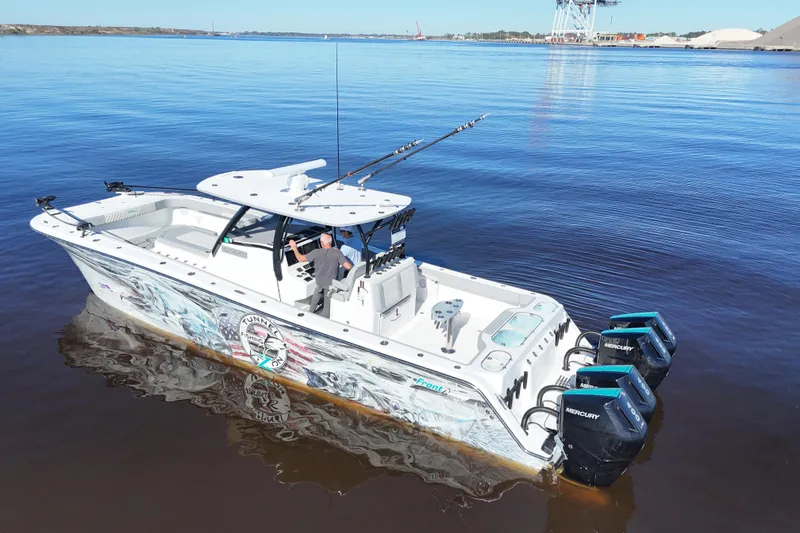 Slide: The Image of 2024 Front Runner 37 Catamaran on calm water, featuring powerful Mercury engines. - 53