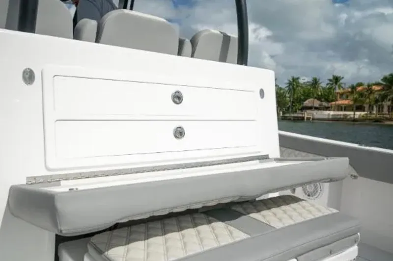 Slide: The Image of 2024 Front Runner 37 Catamaran interior seating with storage, featuring sleek design and coastal backdrop. - 92
