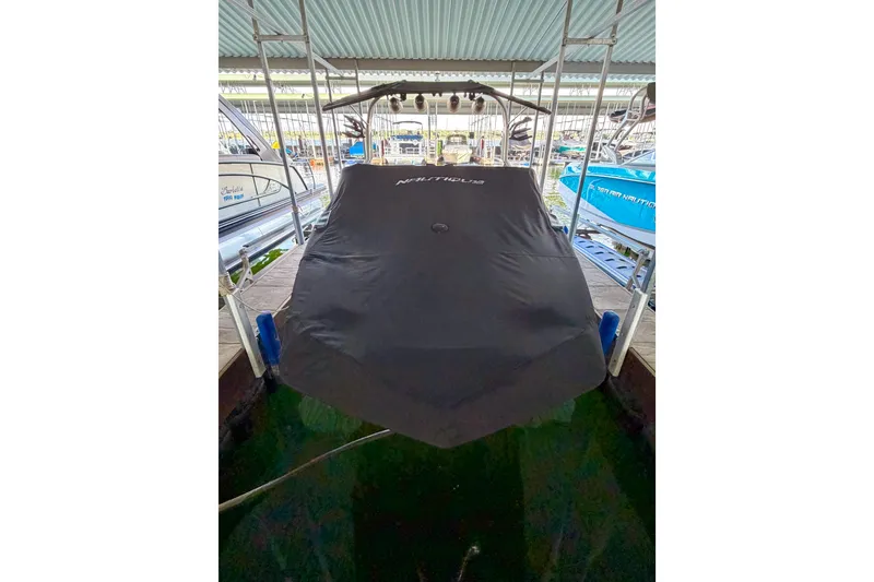 Slide: The Image of 2018 Nautique Super Air Nautique GS24 covered in dock, front view. - 15