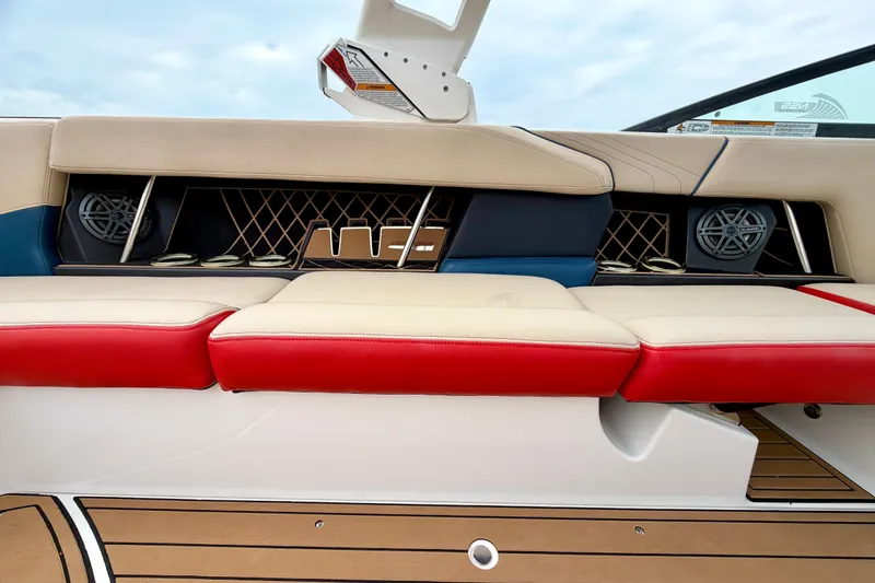 Slide: The Image of 2018 Nautique Super Air Nautique GS24 boat interior with red and beige seating. - 22