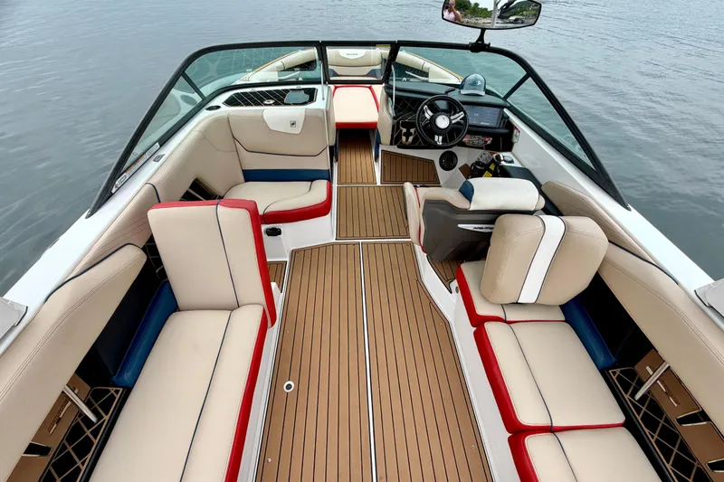Slide: The Image of 2018 Nautique Super Air Nautique GS24 interior with stylish seating and modern dashboard. - 24