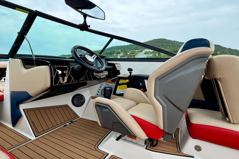 Slide: The Image of 2018 Nautique Super Air Nautique GS24 boat interior with modern dashboard and seating. - 25