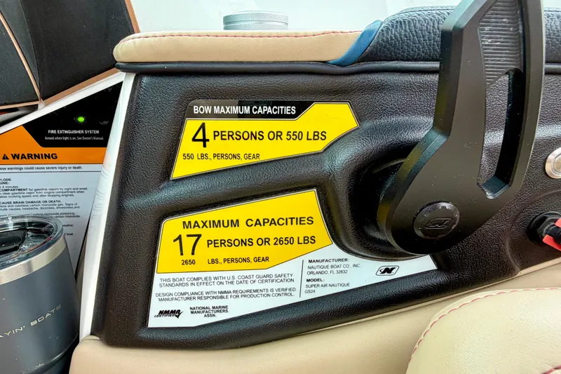 Slide: The Image of 2018 Nautique Super Air Nautique GS24 capacity labels, showing limits for passengers and gear. - 26