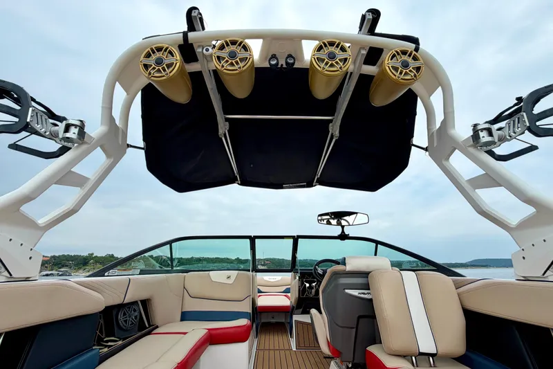 Slide: The Image of 2018 Nautique Super Air Nautique GS24 interior with speakers and seating, lake view. - 28