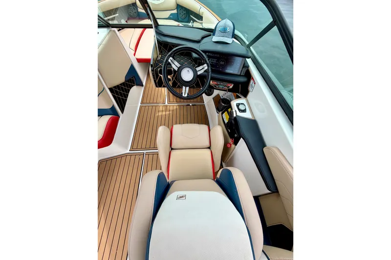 Slide: The Image of 2018 Nautique Super Air Nautique GS24 boat interior with steering wheel and dashboard. - 29